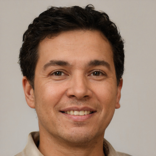 Joyful white adult male with short  brown hair and brown eyes