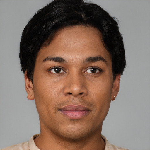 Joyful latino young-adult male with short  black hair and brown eyes