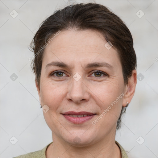 Joyful white adult female with short  brown hair and grey eyes