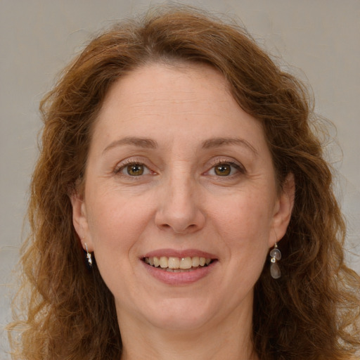 Joyful white adult female with long  brown hair and green eyes