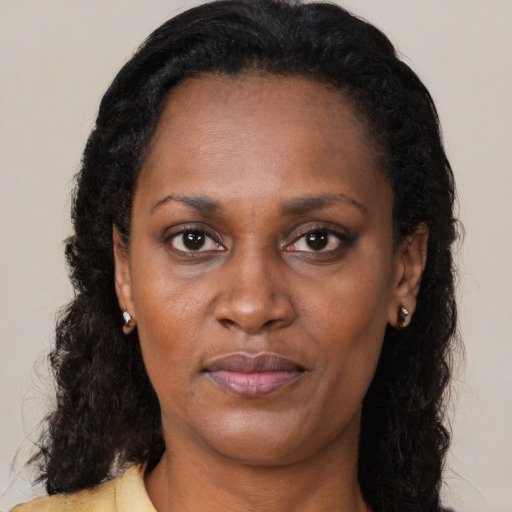 Joyful black adult female with medium  black hair and brown eyes