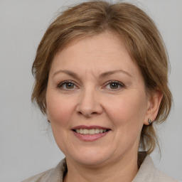 Joyful white adult female with medium  brown hair and grey eyes