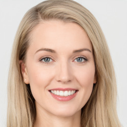 Joyful white young-adult female with long  brown hair and blue eyes