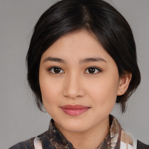 Joyful asian young-adult female with medium  brown hair and brown eyes