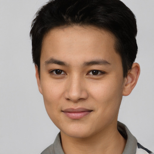 Joyful asian young-adult male with short  brown hair and brown eyes
