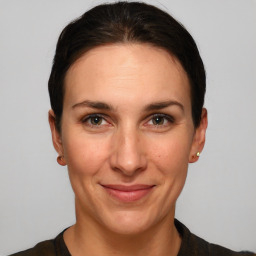 Joyful white adult female with short  brown hair and grey eyes