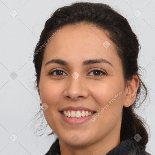 Joyful white young-adult female with long  brown hair and brown eyes