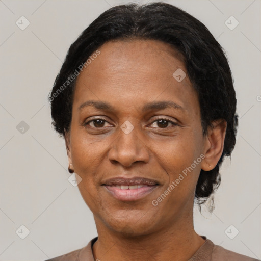 Joyful black adult female with short  black hair and brown eyes