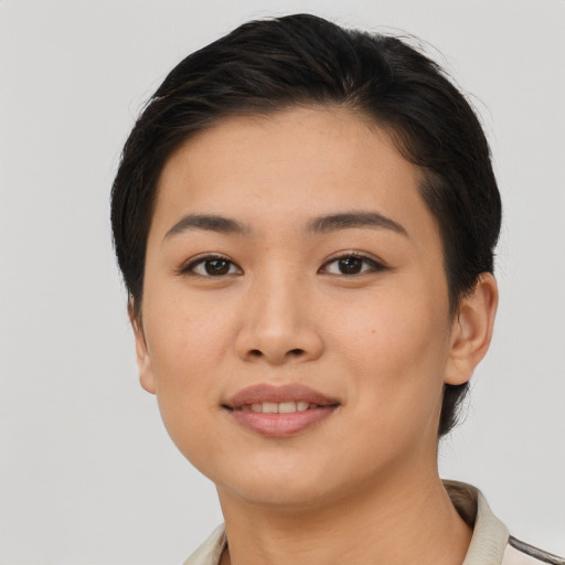 Joyful asian young-adult female with short  black hair and brown eyes