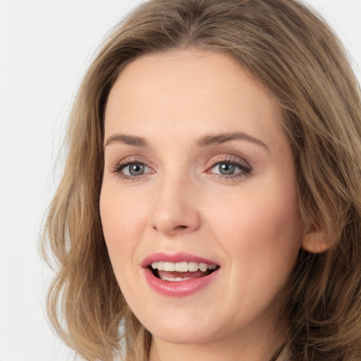 Joyful white young-adult female with long  brown hair and green eyes