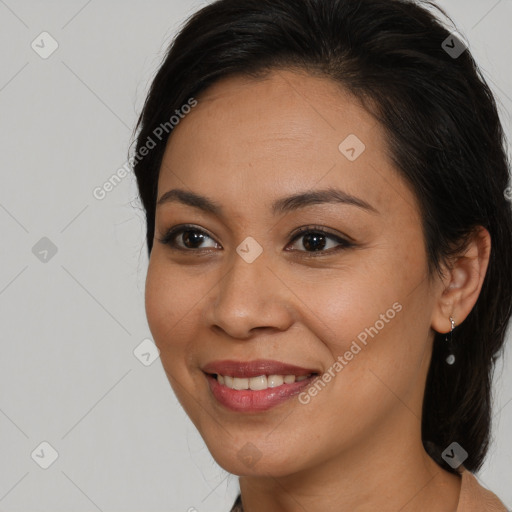 Joyful latino young-adult female with long  brown hair and brown eyes