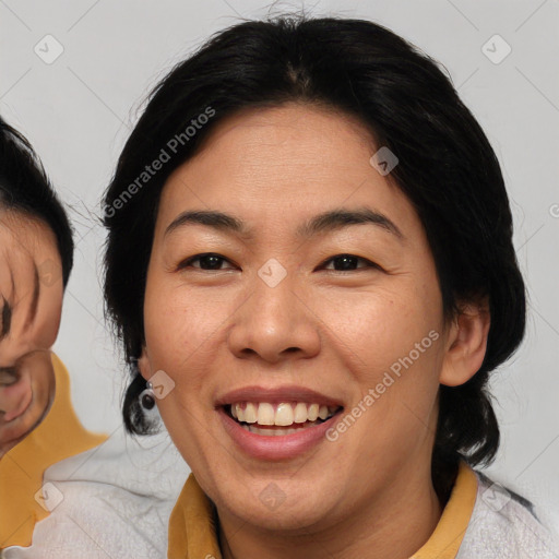 Joyful asian adult female with medium  brown hair and brown eyes