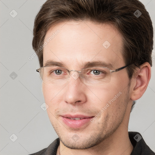 Joyful white adult male with short  brown hair and grey eyes