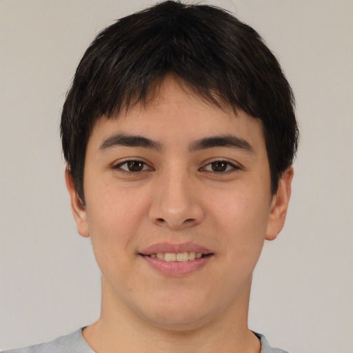 Joyful asian young-adult male with short  brown hair and brown eyes