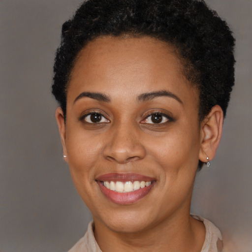 Joyful black young-adult female with short  brown hair and brown eyes