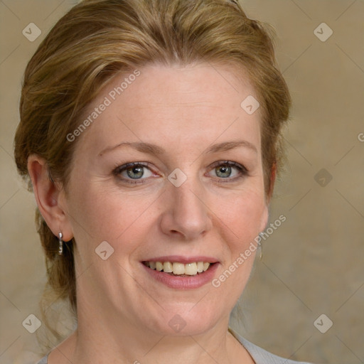 Joyful white adult female with medium  brown hair and blue eyes