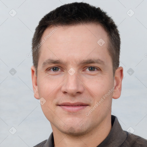 Joyful white young-adult male with short  brown hair and grey eyes