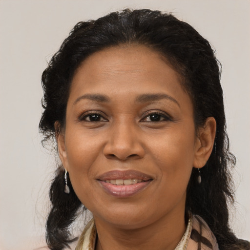 Joyful latino adult female with medium  brown hair and brown eyes