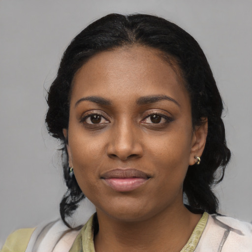 Joyful black young-adult female with medium  black hair and brown eyes