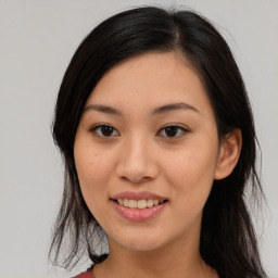 Joyful asian young-adult female with medium  black hair and brown eyes