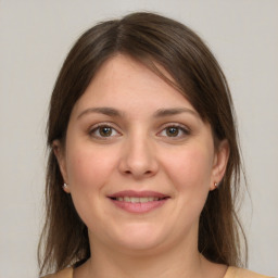 Joyful white young-adult female with medium  brown hair and green eyes