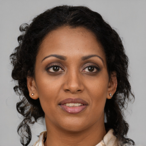 Joyful black young-adult female with medium  brown hair and brown eyes