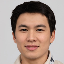 Joyful asian young-adult male with short  brown hair and brown eyes