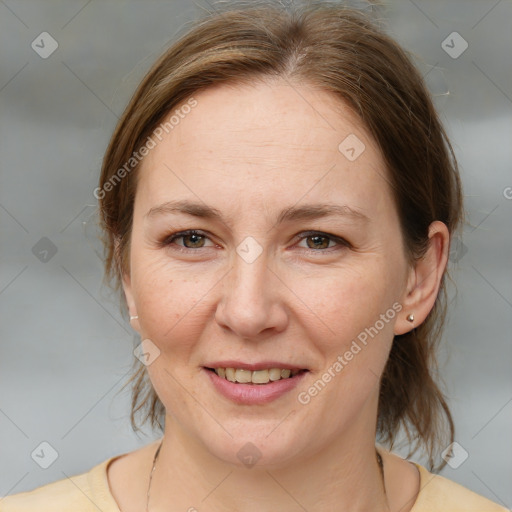 Joyful white adult female with medium  brown hair and brown eyes