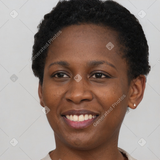 Joyful black young-adult female with short  black hair and brown eyes