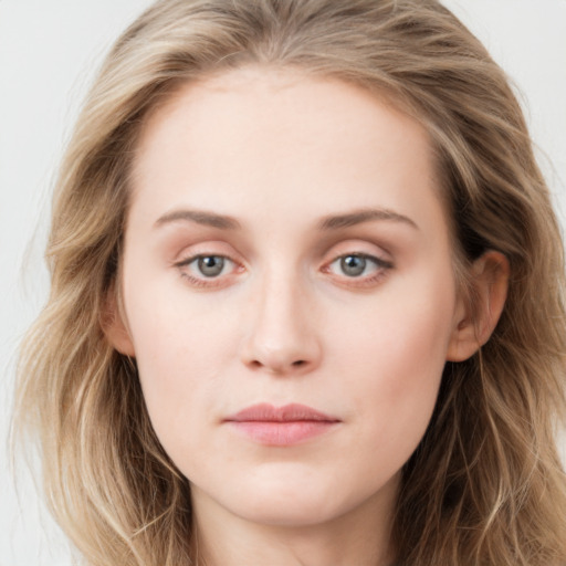 Joyful white young-adult female with long  brown hair and blue eyes