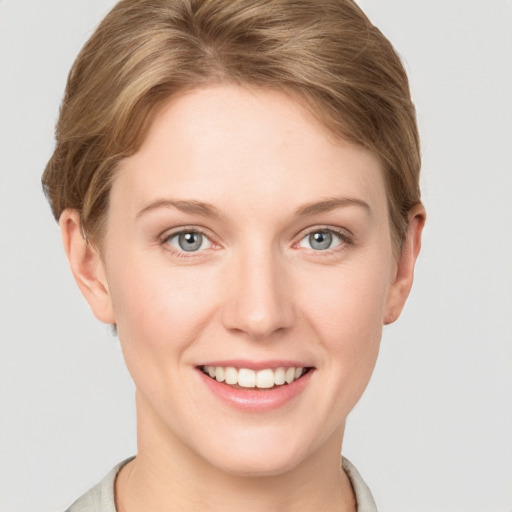 Joyful white young-adult female with short  brown hair and grey eyes