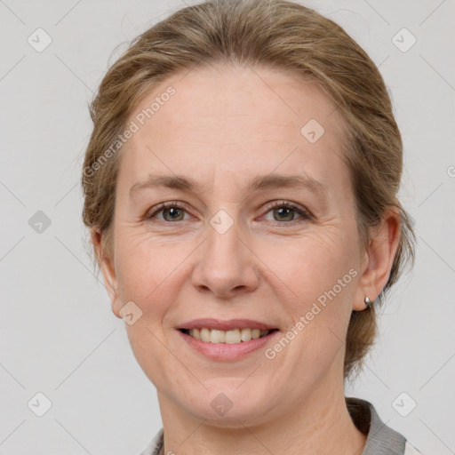 Joyful white adult female with medium  brown hair and grey eyes