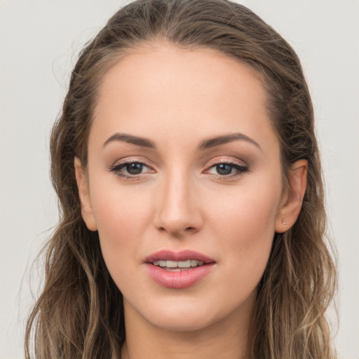 Joyful white young-adult female with long  brown hair and grey eyes