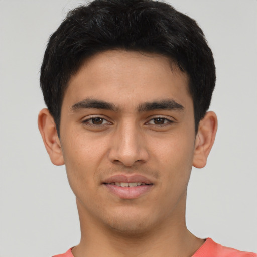 Joyful latino young-adult male with short  brown hair and brown eyes