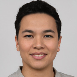 Joyful asian young-adult male with short  black hair and brown eyes