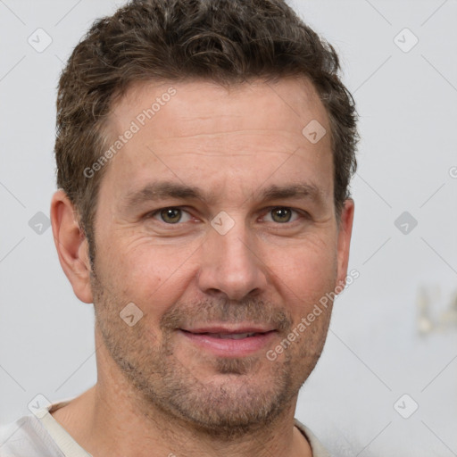 Joyful white adult male with short  brown hair and grey eyes