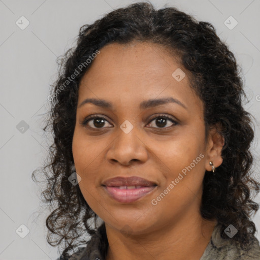 Joyful black young-adult female with long  brown hair and brown eyes