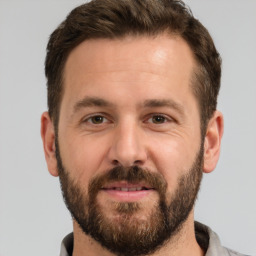 Joyful white adult male with short  brown hair and brown eyes