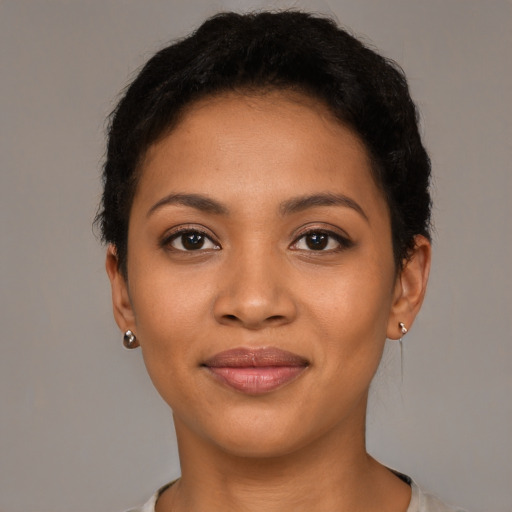 Joyful latino young-adult female with short  brown hair and brown eyes
