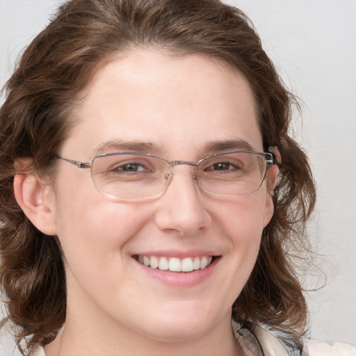 Joyful white adult female with medium  brown hair and blue eyes