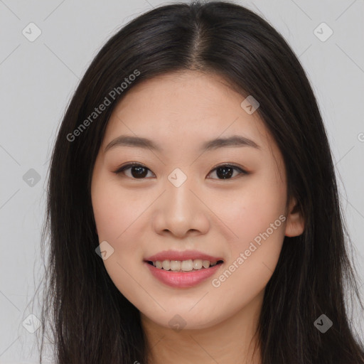 Joyful asian young-adult female with long  brown hair and brown eyes