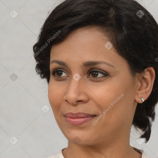 Joyful latino young-adult female with medium  brown hair and brown eyes