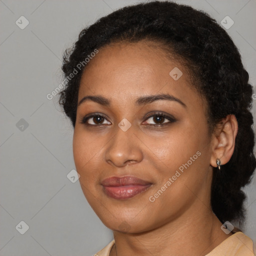 Joyful black young-adult female with short  black hair and brown eyes