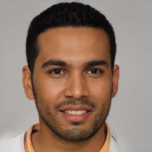 Joyful latino young-adult male with short  black hair and brown eyes
