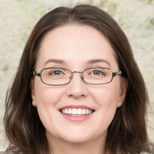 Joyful white adult female with medium  brown hair and green eyes