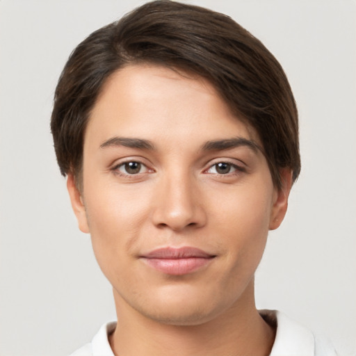 Joyful white young-adult female with short  brown hair and brown eyes