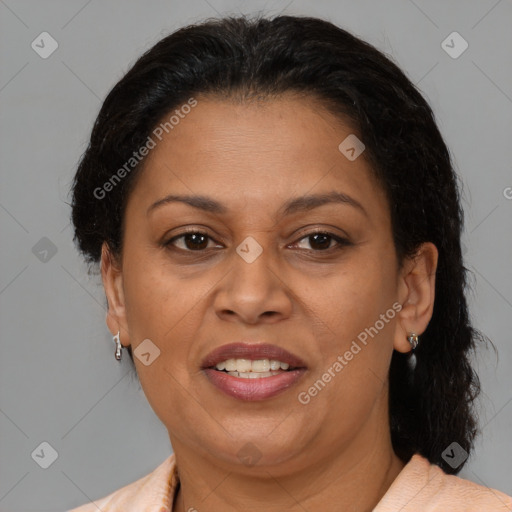 Joyful latino adult female with medium  brown hair and brown eyes