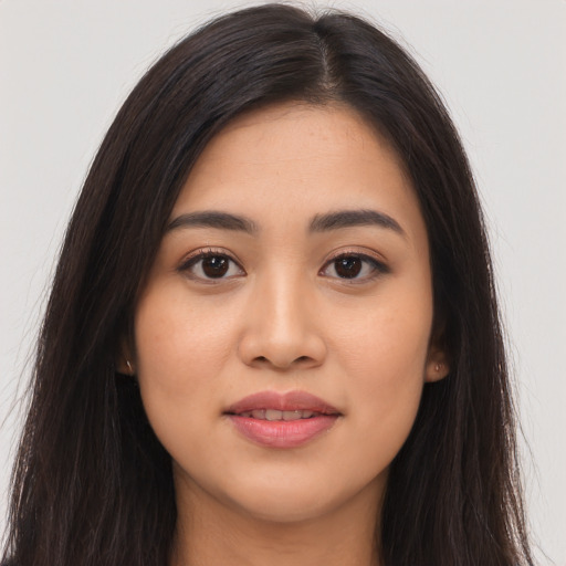 Joyful asian young-adult female with long  brown hair and brown eyes
