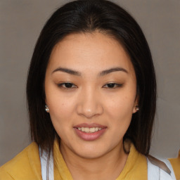 Joyful asian young-adult female with medium  brown hair and brown eyes