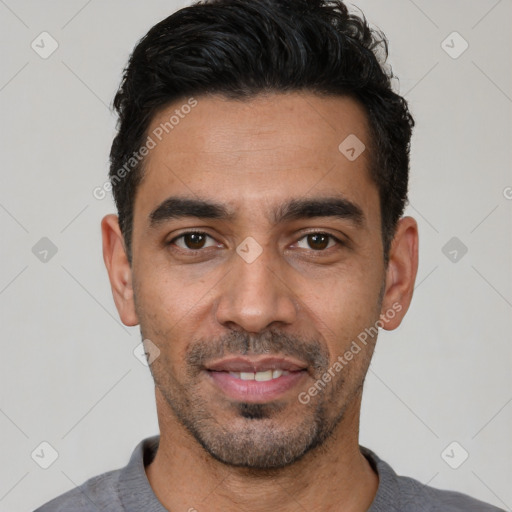 Joyful latino young-adult male with short  black hair and brown eyes